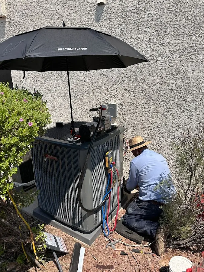 HVAC technician performing outdoor AC maintenance in Heber Springs
