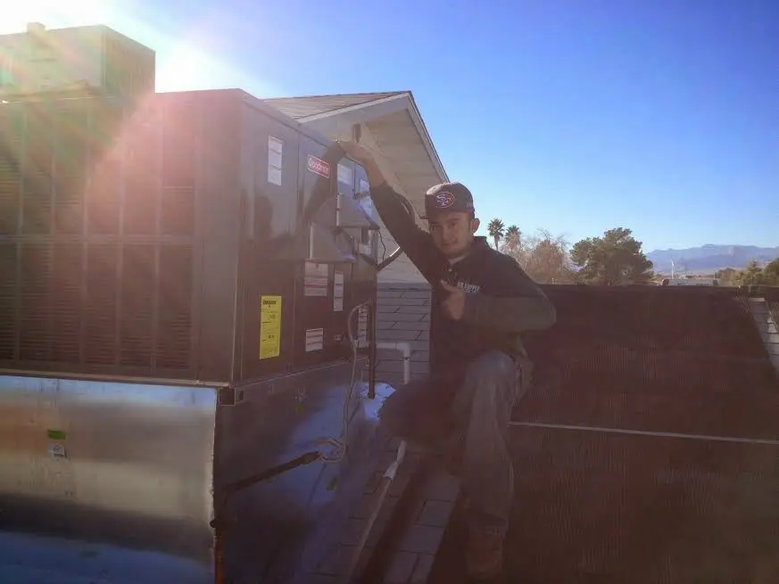HVAC technician performing HVAC Inspection on a rooftop unit in Heber Springs